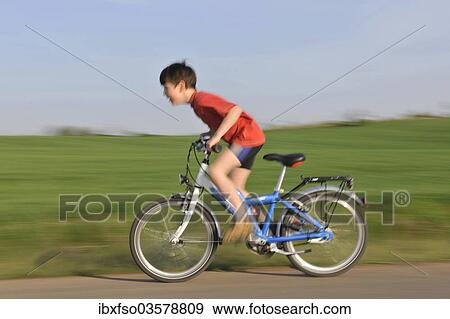 "Boy riding a bicycle on a tarmaced track, Erfurt, Thuringia, Germany, Europe" View Large Photo Image Stock Photo - "Boy riding a bicycle on a tarmaced track, Erfurt, Thuringia, Germany, Europe". Fotosearch