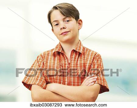 "Boy with his arms crossed, looking cool" View Large Photo Image Stock Image - "Boy with his arms crossed, looking cool". Fotosearch