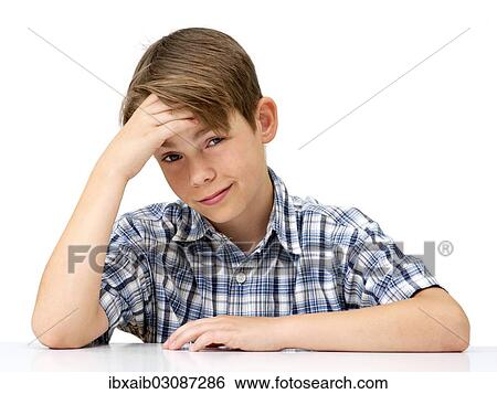 Stock Photograph - "Boy with his hand supporting his head, looking worried, stressed". Fotosearch