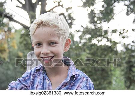 Boy with his tongue sticking out View Large Photo Image Stock Image - Boy with his tongue sticking out. Fotosearch