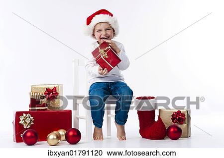 Boy with Santa hat and Christmas gifts View Large Photo Image Stock Image - Boy with Santa hat and Christmas gifts. Fotosearch