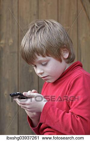 Boy writing a text message View Large Photo Image Stock Image - Boy writing a text message. Fotosearch