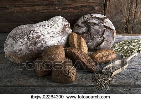"Bread loaves, rolls with rye grain and ears of corn on a rustic wooden surface" View Large Photo Image Stock Image - "Bread loaves, rolls with rye grain and ears of corn on a rustic wooden surface". Fotosearch