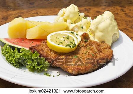 Breaded pork cutlet with boiled potatoes and cauliflower with sauce hollandaise View Large Photo Image Stock Image - Breaded pork cutlet with boiled potatoes and cauliflower with sauce hollandaise. Fotosearch