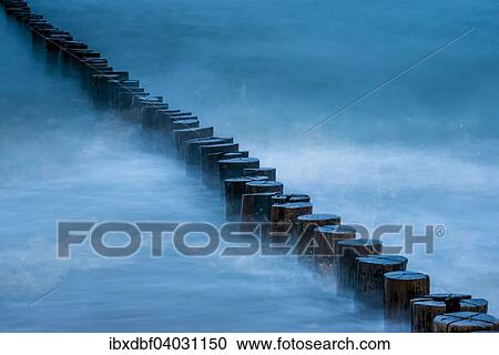 Stock Image - "Breakwaters or groins, blue hour, Baltic Sea, Zingst Fischland-Darss-Zingst peninsula, Mecklenburg-Western Pomerania, Germany, Europe". Fotosearch