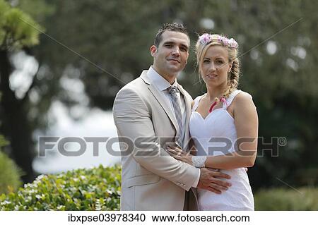 Bride and groom posing in a park View Large Photo Image Stock Image - Bride and groom posing in a park. Fotosearch