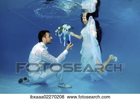 "Bride and groom, underwater wedding in a pool" View Large Photo Image Stock Photo - "Bride and groom, underwater wedding in a pool". Fotosearch