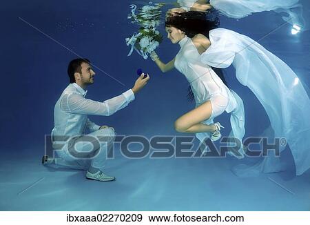 "Bride and groom, underwater wedding in a pool" View Large Photo Image Stock Photo - "Bride and groom, underwater wedding in a pool". Fotosearch