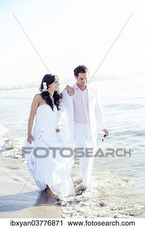"Bride and groom walking on the beach, Spain, Europe" View Large Photo Image Stock Image - "Bride and groom walking on the beach, Spain, Europe". Fotosearch