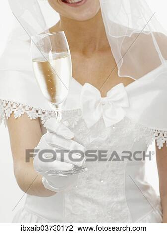 Stock Image - Bride holding a glass of champagne. Fotosearch