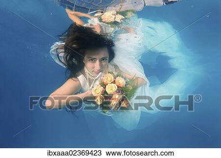 Stock Image - "Bride, underwater wedding in a pool, Odessa, Ukraine, Eastern Europe, Europe". Fotosearch