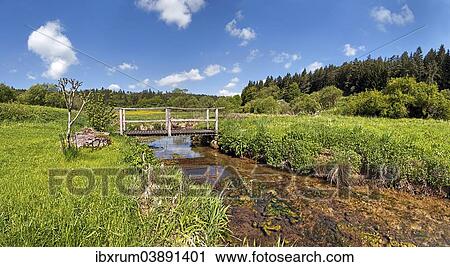 Stock Image - "Bridge over the Morsbach stream with green meadows, Altmuhltal Nature Park, Bavaria, Germany, Europe". Fotosearch
