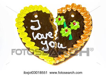 Stock Image - "Broken gingerbread heart with the message """"I love you"""", symbolic image for separation or divorce". Fotosearch