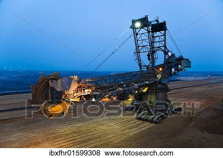 "Bucket-wheel excavator changing its location in an open pit, Grevenbroich, North Rhine-Westphalia, Germany, Europe" View Large Photo Image Stock Photo - "Bucket-wheel excavator changing its location in an open pit, Grevenbroich, North Rhine-Westphalia, Germany, Europe". Fotosearch