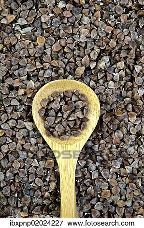 Buckwheat and a spoon View Large Photo Image Stock Photo - Buckwheat and a spoon. Fotosearch