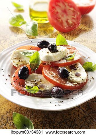 Stock Image - "Buffalo mozzarella, basil, olives and tomato salad". Fotosearch