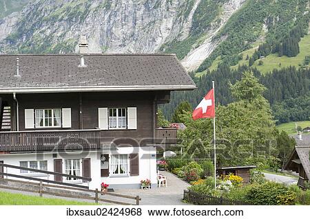 Stock Photo - "Building, Swiss national flag, Grindelwald, Bernese Oberland, Canton of Bern, Alps, Switzerland, Europe". Fotosearch