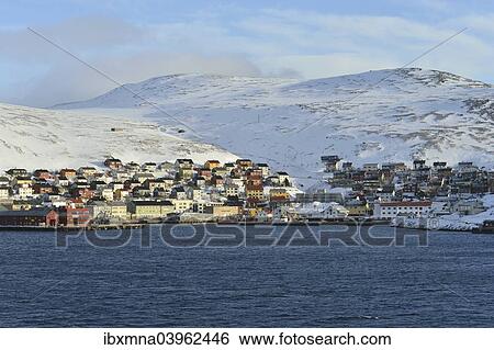 Stock Photograph - "Buildings at the harbour in front of the mountains of the island, Honningsvag, Mageroya island, Finnmark County, Norway, Europe". Fotosearch
