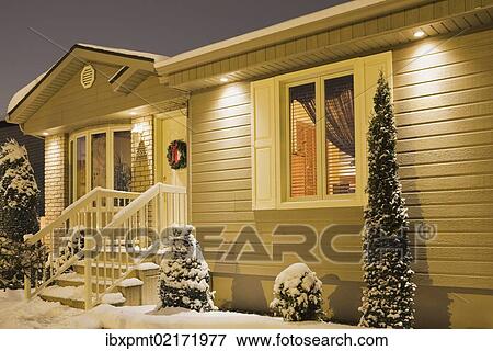 "Bungalow style residential home illuminated in winter at dusk with Christmas decorations, Quebec, Canada, North America" View Large Photo Image Stock Photo - "Bungalow style residential home illuminated in winter at dusk with Christmas decorations, Quebec, Canada, North America". Fotosearch