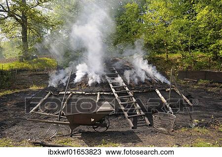 "Burning charcoal pile in the final stage, Walpersdorf, Siegen-Wittgenstein district, North Rhine-Westphalia, Germany, Europe" View Large Photo Image Stock Image - "Burning charcoal pile in the final stage, Walpersdorf, Siegen-Wittgenstein district, North Rhine-Westphalia, Germany, Europe". Fotosearch