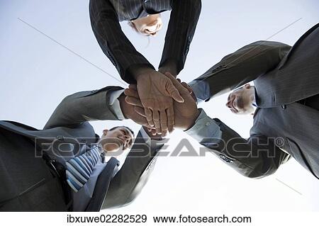 Business team joining hands to celebrate their success View Large Photo Image Stock Photo - Business team joining hands to celebrate their success. Fotosearch