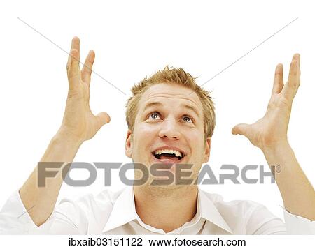 Stock Image - Businessman cheering with his hands raised. Fotosearch