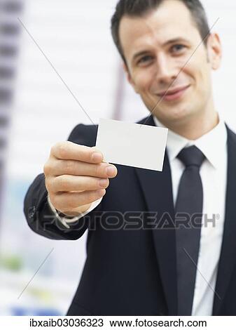 Businessman holding a blank business card View Large Photo Image Stock Image - Businessman holding a blank business card. Fotosearch