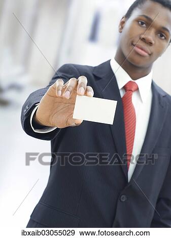 Businessman holding a blank business card View Large Photo Image Stock Photo - Businessman holding a blank business card. Fotosearch