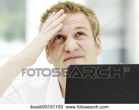 Businessman holding a hand on his wrinkled forehead View Large Photo Image Stock Image - Businessman holding a hand on his wrinkled forehead. Fotosearch