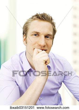 Businessman holding his hand on his chin View Large Photo Image Stock Image - Businessman holding his hand on his chin. Fotosearch