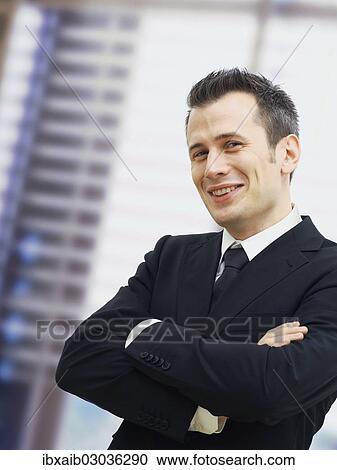 "Businessman in an office, smiling, with his arms crossed" View Large Photo Image Stock Image - "Businessman in an office, smiling, with his arms crossed". Fotosearch