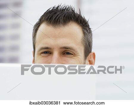 Businessman in an office with a laptop View Large Photo Image Stock Image - Businessman in an office with a laptop. Fotosearch