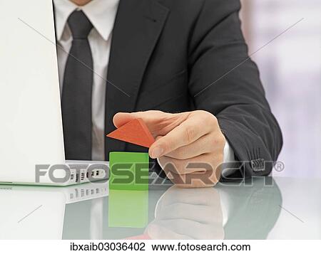 "Businessman in an office with a laptop, building a house out of blocks" View Large Photo Image Stock Image - "Businessman in an office with a laptop, building a house out of blocks". Fotosearch