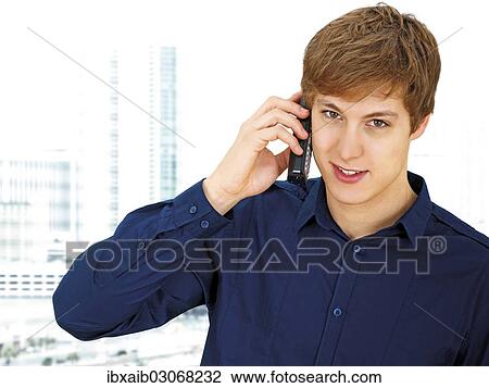 Businessman making a phone call in an office View Large Photo Image Stock Image - Businessman making a phone call in an office. Fotosearch