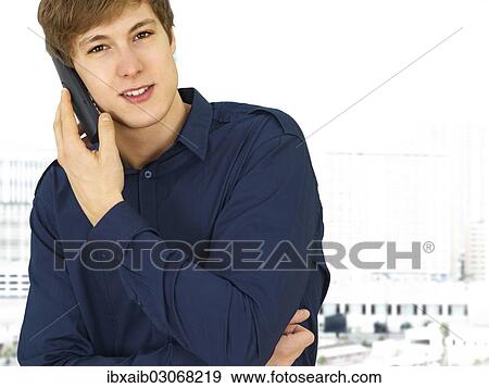 Businessman making a phone call in an office View Large Photo Image Stock Photo - Businessman making a phone call in an office. Fotosearch