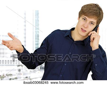 Businessman making a phone call in an office View Large Photo Image Stock Photography - Businessman making a phone call in an office. Fotosearch
