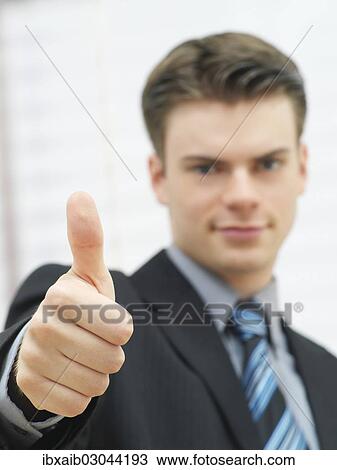 Businessman making a thumbs up gesture View Large Photo Image Stock Image - Businessman making a thumbs up gesture. Fotosearch