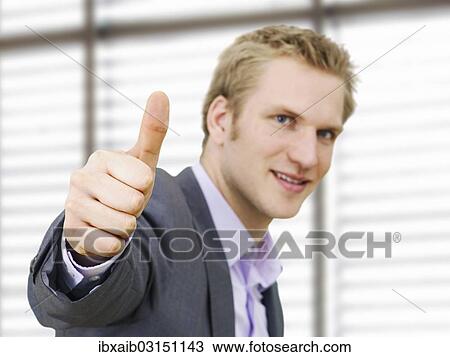 Stock Image - Businessman making a thumbs-up gesture. Fotosearch
