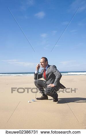 Businessman playing golf on the beach View Large Photo Image Stock Image - Businessman playing golf on the beach. Fotosearch