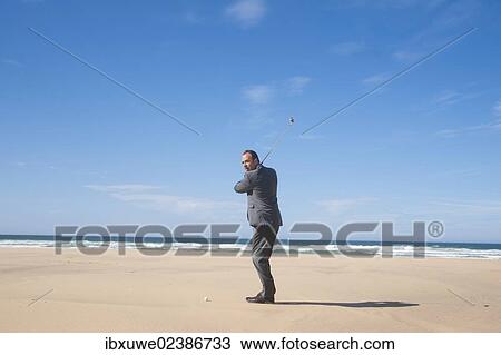 Businessman playing golf on the beach View Large Photo Image Stock Image - Businessman playing golf on the beach. Fotosearch