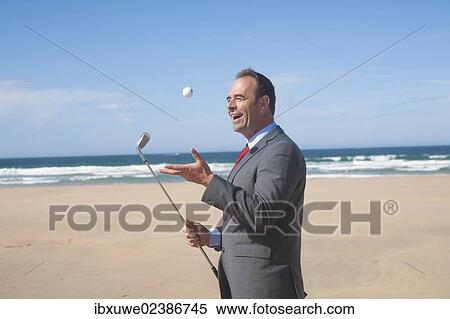 Businessman playing golf on the beach View Large Photo Image Stock Photography - Businessman playing golf on the beach. Fotosearch