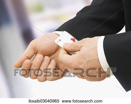 Businessman pulling an ace out of his sleeve View Large Photo Image Stock Photography - Businessman pulling an ace out of his sleeve. Fotosearch