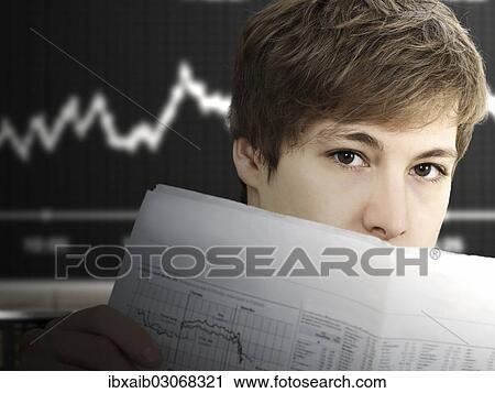 Businessman reading a newspaper at the stock exchange View Large Photo Image Stock Image - Businessman reading a newspaper at the stock exchange. Fotosearch