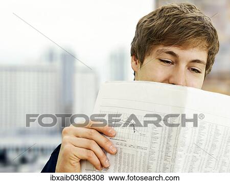 Businessman reading a newspaper in an office View Large Photo Image Stock Photo - Businessman reading a newspaper in an office. Fotosearch