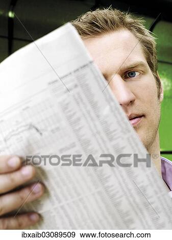 "Businessman reading a newspaper, looking serious, concentrating" View Large Photo Image Stock Photo - "Businessman reading a newspaper, looking serious, concentrating". Fotosearch