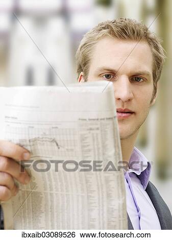 "Businessman reading a newspaper, concentrating" View Large Photo Image Stock Photograph - "Businessman reading a newspaper, concentrating". Fotosearch