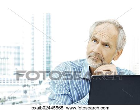 "Businessman, senior, boss, retiree, professor, teacher, behind a laptop with a thoughtful expression" View Large Photo Image Stock Photography - "Businessman, senior, boss, retiree, professor, teacher, behind a laptop with a thoughtful expression". Fotosearch