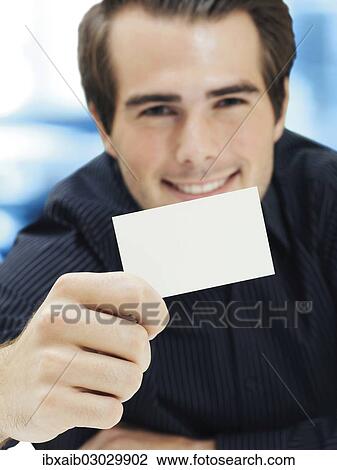 Stock Image - Businessman showing blank business card. Fotosearch