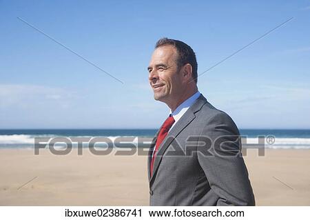 Businessman standing at the beach View Large Photo Image Stock Image - Businessman standing at the beach. Fotosearch