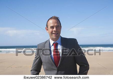 Businessman standing at the beach View Large Photo Image Stock Image - Businessman standing at the beach. Fotosearch